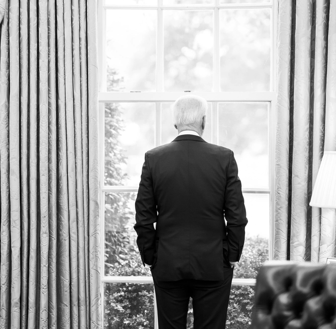 Joe Biden reflects whilst standing at Oval Office window looking out